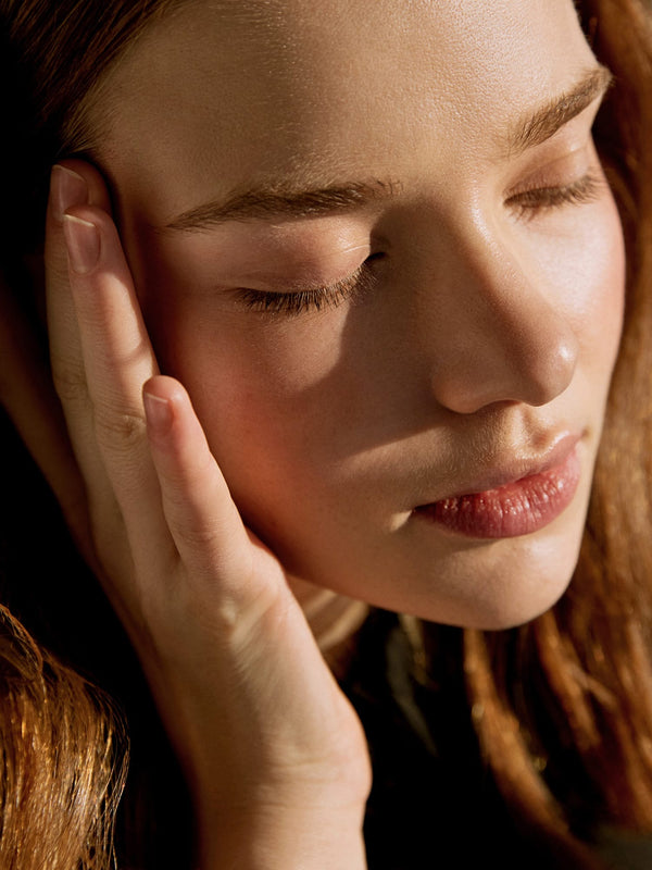 LALO Skincare - Woman touching cheek